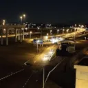 Highway at night with several car headlamps visible