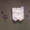 A colourful sign inside a cafe with the number 150 visible in purple
