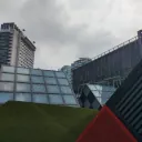 A couple of cube like structures with a background of grey clouds
